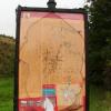 Tablica informacyjna pod ruinami, zniszczona bardzo, mokunka